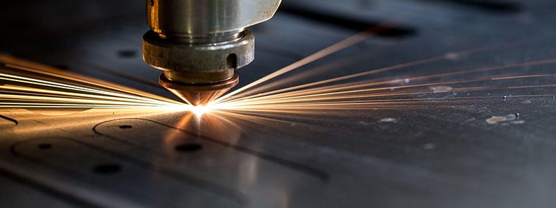 Cutting of metal. Sparks fly from laser